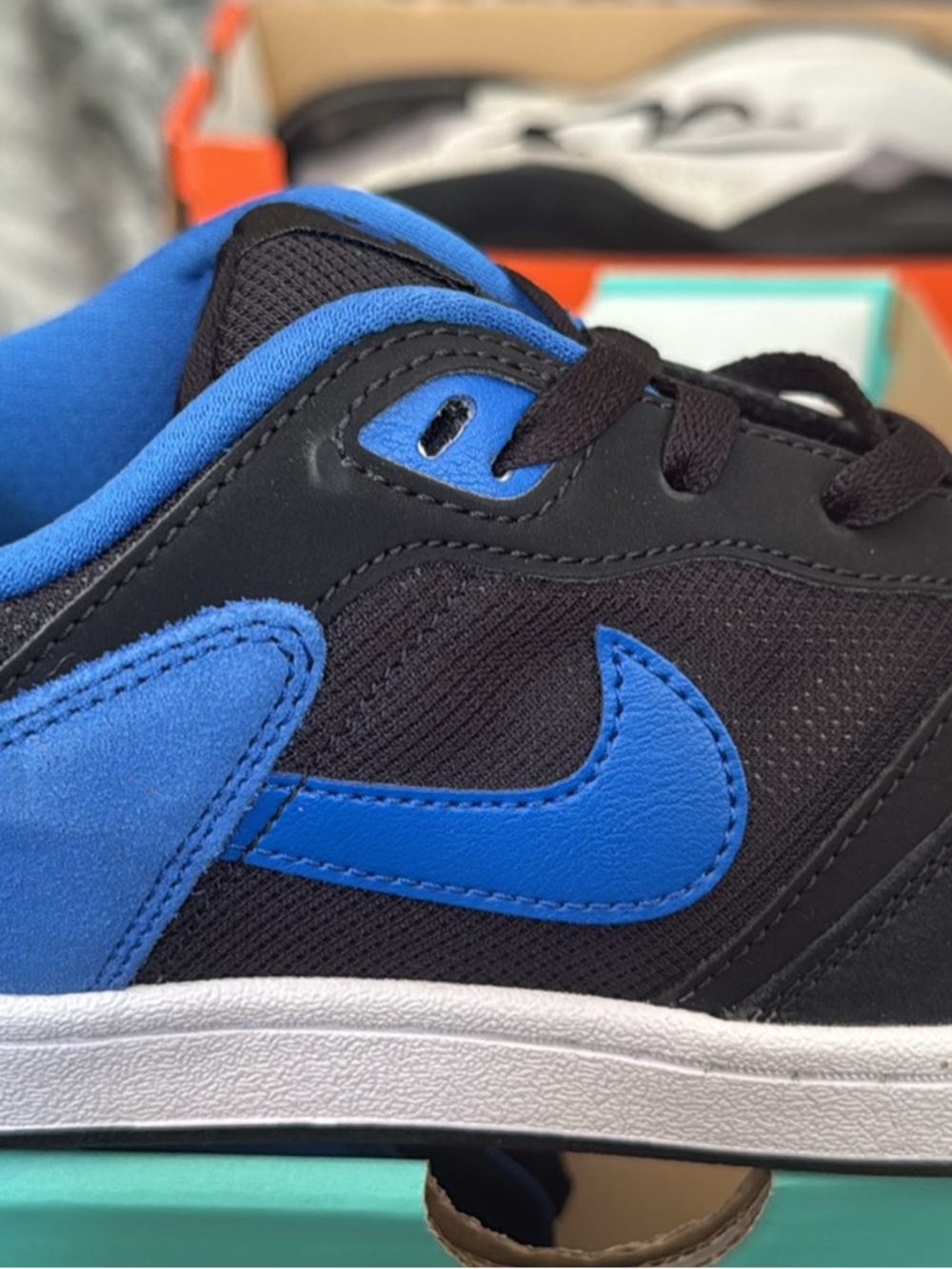 Nike Kids Black and Blue Low-Top Sneakers with Bright Blue Swoosh